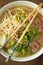 Ramen soup with noodle with meat, fresh herbs and vegetables