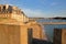 The ramparts of the walled city of Saint Malo at sunset, with the Mole beach and the harbor in the background, Saint Malo