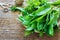 Ramson bear garlic bunchand parsley tied with rope a wooden background