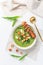 Ramson or bear leek soup with crouton, sour cream and turkey skewer