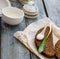 Ramson with rye bread and sour cream with salt, on a gray board,