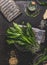 Ramson, wild garlic, leaves bunch on dark rustic kitchen table background with ingredients, top view. Healthy cooking still life.