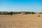 Ranautar,  remote desert village inside the desert. Distant horizon, Hot summer with cloudless clear blue sky background, Thar