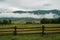 Ranch and barn in rural Idaho Swan Valley going into the Teton Mountain range on a rainy, foggy summer day