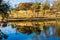 Ranch House and Fall Color Reflecting In Water of Calm Lake on Hill Country Ranch