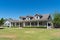 Ranch style home with porch and dormers