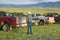 Rancher and cowboy looking at pickup trucks in Centennial Valley, near Lakeview, MT