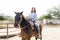 Rancher Smiling While Riding Brown Horse