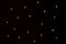 Random small white star shape dots on black background