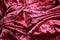 Randomly crumpled velvet fabric, abstract pink and burgundy background. space for lettering and design. Selective focus