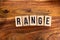 ` RANGE ` text made of wooden cube on  wooden background