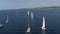 Ranks from yachts of participants of a regatta goes on a start point, is a sailing race at Croatia, reflection of sails