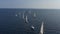 Ranks from yachts of participants of a regatta goes on a start point, is a sailing race at Croatia, reflection of sails