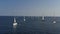 Ranks from yachts of participants of a regatta goes on a start point, is a sailing race at Croatia, reflection of sails