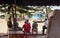 Ranohira, Madagascar - May 05, 2019: Group of local Malagasy men sitting in front of shop on sunny day, just watching the street