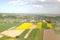 Rapeseed fields from the height of bird flight. Shooting from the drone or aircraft. Agricultural business. Growing oil plants for