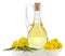 Rapeseed oil and flowers isolated over white.