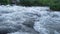 Rapid flow of water from a mountain river. Water surface for background