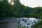 Rapid mountain river with a powerful rushing stream of water in the forest