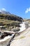 Rapid stream, bridge and mountain panorama, Hohe Tauern Alps, Austria