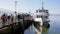 Rapperswil jona, sankt gallen, switzerland - february 20, 2021: pier at noon, waiting passengers board the sÃ¤ntis ship for a