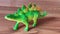 This rare ancient animal is named Stegosaurus in the form of a green toy statue 2