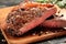 Rare New York strip steak on wooden board, selected focus