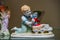 Rare porcelain figurine on a glass shelf. Boy playing with toys