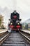 Rare steam train locomotive preparing for departure from railway station, vertical image