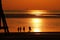 Rare sunset at a beach with people's silhouettes during a heatwave in United Kingdom