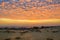 Rare sunset view from the sand dunes of the village Mui Ne, the sea and the distant horizon