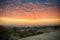 Rare sunset view from the sand dunes of the village Mui Ne, the sea and the distant horizon