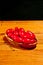 Rare wood bowel of cherry tomatoes on a wood cutting board