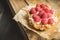 Rasberry cake decorated with fresh ripe berries on the rustic background