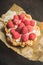 Rasberry cake decorated with fresh ripe berries on the rustic background