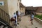 Rasnov, Brasov, Romania - June 15, 2019: Tourist walking thru Rasnov Fortress courtyard admiring souvenirs shops