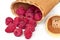 Raspberries in bark basket on a white background from the top