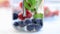 Raspberries, blueberries, and mint drink inside a jar