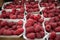 Raspberries in containers on a stall forming a background