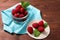 Raspberries in a glass container and on a string circle