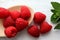 Raspberries and mint leaves on shabby looking wooden table