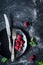 Raspberries, vintage cutlery and black plate