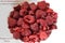 Raspberries on a white plate.. Book of Sirach 35, 10 from the Bible.