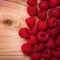 Raspberries on Wooden Background.