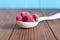 Raspberries in wooden spoon on rural wood