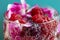 raspberry berries and flower petals in water with rolls close-up