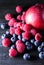 Raspberry, blueberry and nectarine on dark wooden background, st