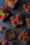 Raspberry brownies served with fresh berries on blue background