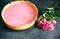 Raspberry cheesecake with rose flowers. Tasty present for Valentine`s holiday or Mother`s day. Beautiful flat lay on the kitchen