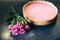 Raspberry cheesecake with rose flowers. Tasty present for Valentine`s holiday or Mother`s day. Beautiful flat lay on the kitchen
